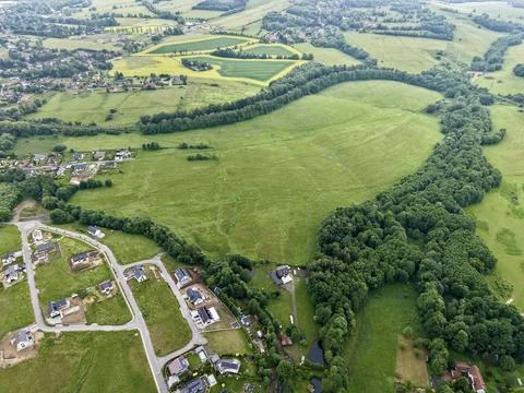 Aerial view of rural landscape with patchwork fields, woodland belt and sub.. 스톡 사진