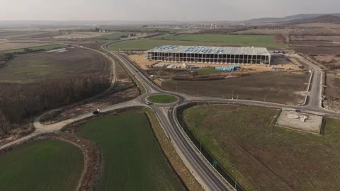 An aerial view of a rural roundabout intersection connecting multiple roads Stock Footage 332549785