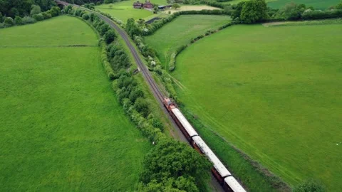 Aerial view of a rural train through the British countryside Stock Footage 200830641