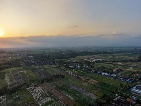 Aerial view of rural village fields and farmland at sunset Stock Photos