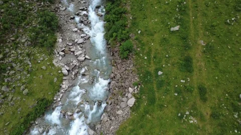 Aerial View of a Rushing Mountain Stream in the Austrian Alps During Summer. Stock Footage 330481924