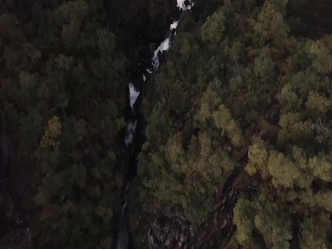 Aerial View of Rushing Waterfall through Deep Epic Valley of Rock and Forest Видео 82981040
