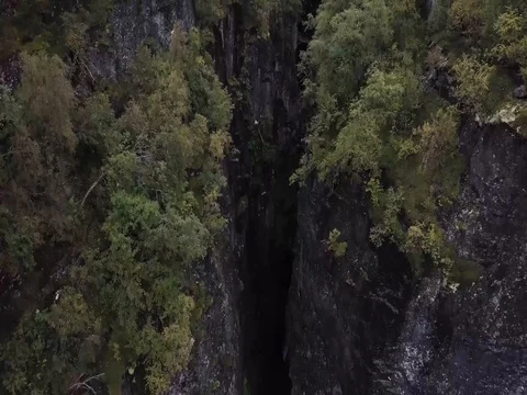 Aerial View of Rushing Waterfall through Deep Epic Valley of Rock and Forest 스톡 동영상 82981197