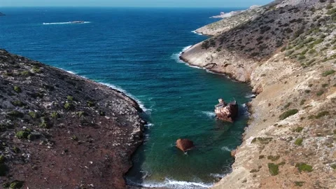 Aerial view of the rusting Olympia shipwreck in a small cove at Liveros Bay on Stock Footage 346496082