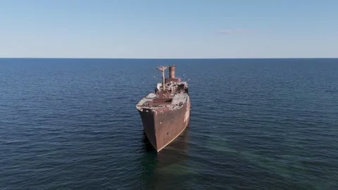 Aerial View of Rusty Cargo Shipwreck Abandoned in the Middle of the Sea Stock Footage 335441266