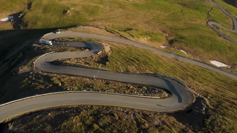 Aerial view of RV / Campervan driving on Transalpina mountain road, Romania	 Stock Footage 156652017