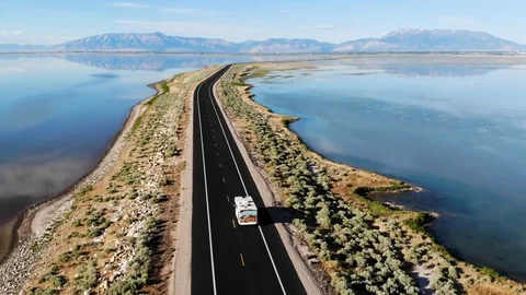Aerial view of rv driving on Antelope Island Rd, Great Salt Lake, Utah, USA Stock Footage