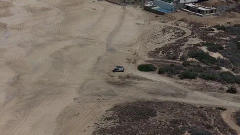 Aerial view of an RV parked on a sandy beach near Cabo San Lucas, Baja Stock Footage 345373987