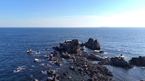 Aerial View of Sacred Mitsuishi Rocks and Shimenawa Rope Stock Footage 329059422