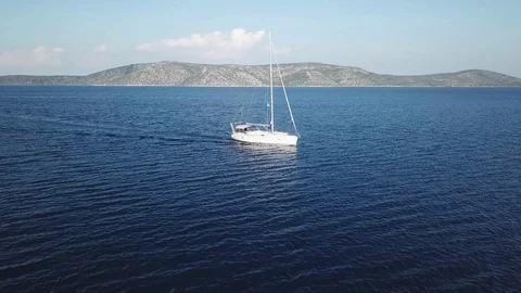 Aerial view , Sailboat sailing on a deep blue sea , in a channel between two isl Stock Footage 96295261