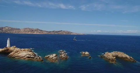 Aerial view of a sailing boat navigating off the coast of Porto Rotondo, Ital Stock Footage 84905380