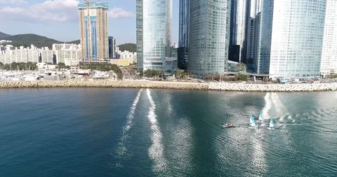 Aerial view of a sailing dinghy out to sea in Haeundae Busan South Korea Stock Footage 100960381