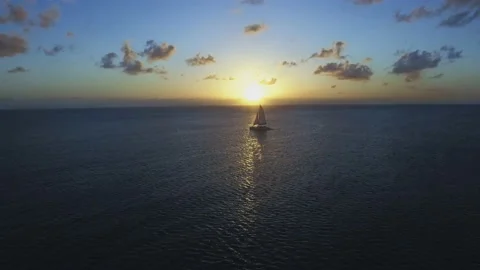 Aerial view of the sailing ship at sunset in the Caribbean Sea. Video stock 107403039