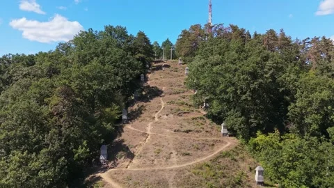 Aerial view of Salgótarján Three-Cross Calvary on wooded hillside in Hungary Stock Footage 346152550