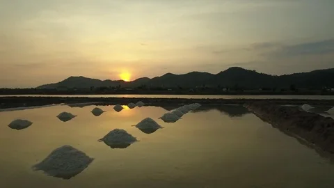 Aerial view of salt worker gathering salt on the salines, Cambodia Stock Footage 83535260