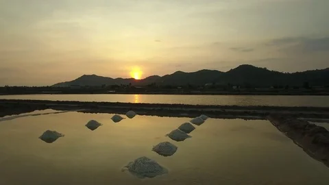 Aerial view of salt worker gathering salt on the salines, Cambodia Stock Footage 83535268