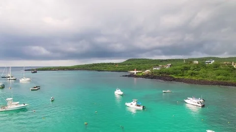 Aerial view of San Cristobal island coast, harbour with boats, Galapagos Stock Footage