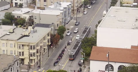 Aerial view of San Francisco Mission District intersection and Muni Tram Stock Footage