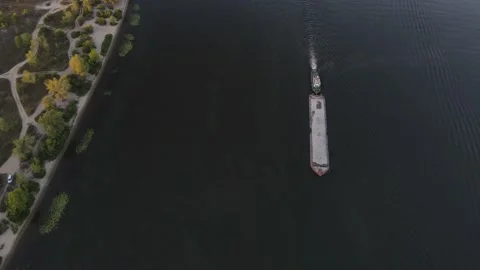 Aerial view of a sand barge sailing on a river near the shore Stock Footage 149080143