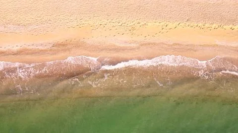 Aerial view of sand beach. Top view sea waves. Drone footage Stock Photos