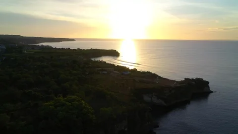 Aerial view of a sand beach under mountain cliff on background with beautiful Stock Footage 128115584