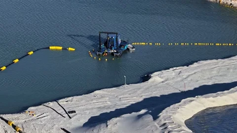 Aerial view of a sand dredger pump working in a quarry lake for mining Stock Footage 336289849