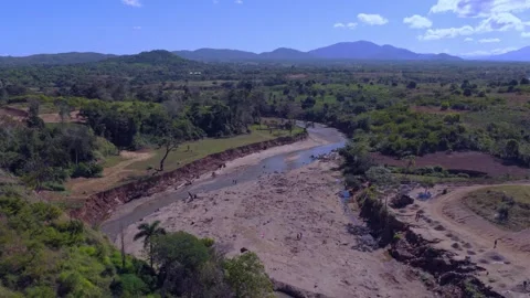 Aerial view of sand mining and erosion on the Massacre River in Haiti Stock Footage 328832384