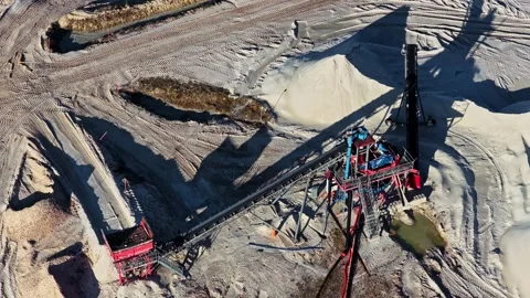 Aerial view of a sand pit with a conveyor belt and processing machinery Stock Footage 336307344
