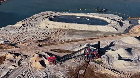 Aerial view of a sand quarry with dredging equipment and conveyor belts Stock Footage 337790908