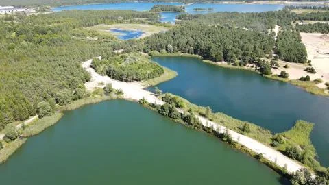 Aerial view of sand quarry mining road between artificial lakes Stock Photos
