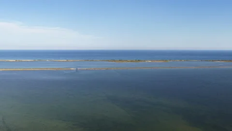 Aerial view of sandbar separating calm lagoon and Mediterranean Sea, Stock Footage 338013988