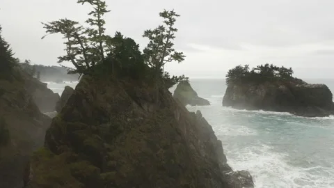 Aerial view of sandstone cliffs, washed by mighty, foamy waves beyond foggy sky 스톡 동영상 168104689