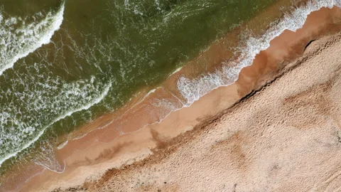 Aerial view of the sandy beach and sea waves. Vacation at sea. Video stock 148074694