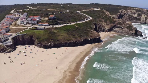 Aerial view of sandy beach and small town on rocky cliff. Stock Footage 150841759