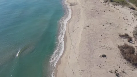 Aerial View of Sandy Beach and Turquoise Sea Waves Stock Footage 324529028