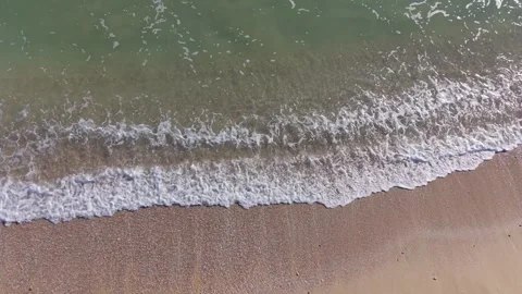 Aerial View of Sandy Beach and Gentle Waves Along Coastline Stock Footage 325720085