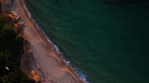 Aerial view of the sandy beach and turquoise waves at sunset, Italy. Stock Footage 334153393