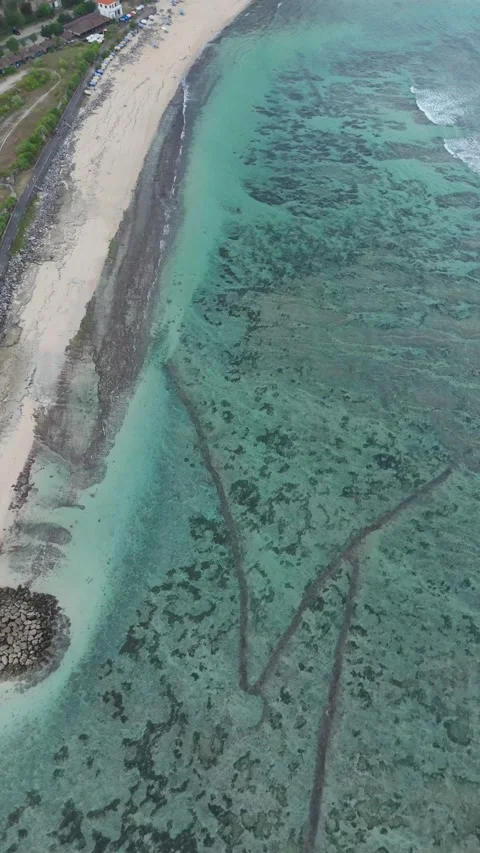 Aerial View of a Sandy Beach and Turquoise Reef Water, East Bali Video stock 337310238