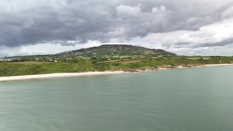 Aerial View of Sandy Beach and Green Coastline Under Cloudy Sky 4K 库存影片 337846677