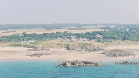 Aerial view of the sandy beach and rocky coastline at Frehel, with the Camping Stock Footage 346677333