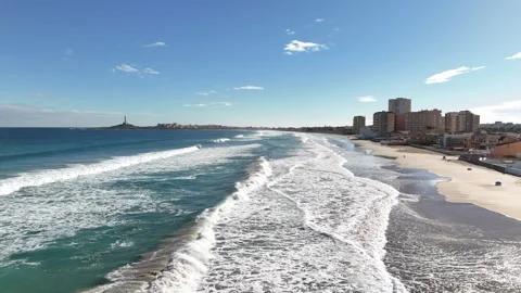 Aerial view of sandy beach coastline with waves and seaside city Stock Footage 340338523