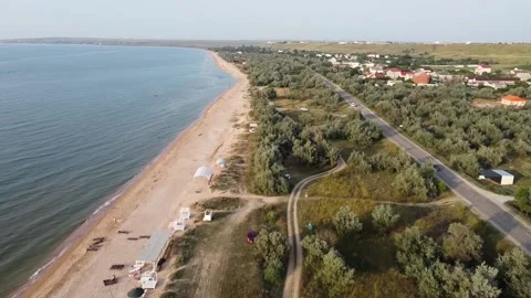Aerial view of sandy beach during golden hour. Dolly shot. Stock Footage 164453637