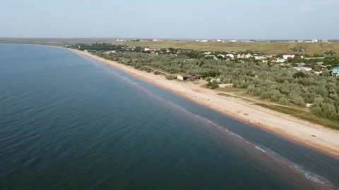 Aerial view of sandy beach during golden hour. Dolly shot. Stock Footage 164453708