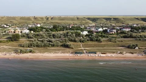 Aerial view of sandy beach during golden hour. Tracking shot, right to left. Stock Footage 164453756