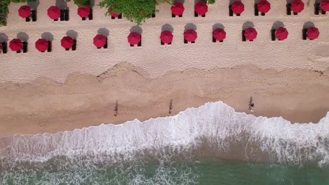 An Aerial View of a Sandy Beach Featuring Colorful Red Umbrellas and Gentle Stock Footage 319457220