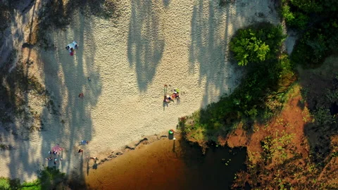 Aerial view of a sandy beach with a resting people near river. Drone take off Stock Footage 148631058