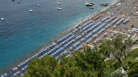 Aerial view of sandy beach with rows of umbrellas, swimming people in sea Italy Stock Footage 112903591