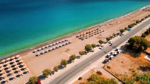 Aerial view of sandy beach with sun umbrellas and turquoise sea water. Greece Stock Footage 301543654