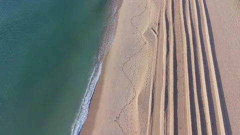 Aerial view of sandy beach with sunbeds and ocean waves Stock Footage 332129230