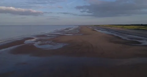 Aerial view of a sandy beach at sunset Stock Footage 77414546